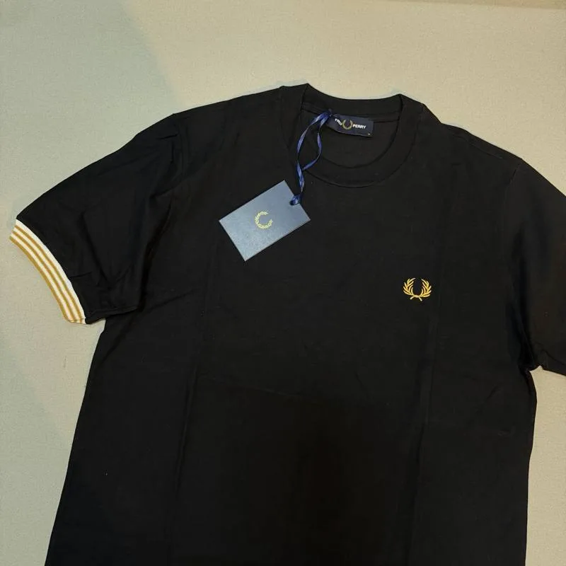 Camiseta Fred Perry preta logo dourado e detalhe dourado/branco manga